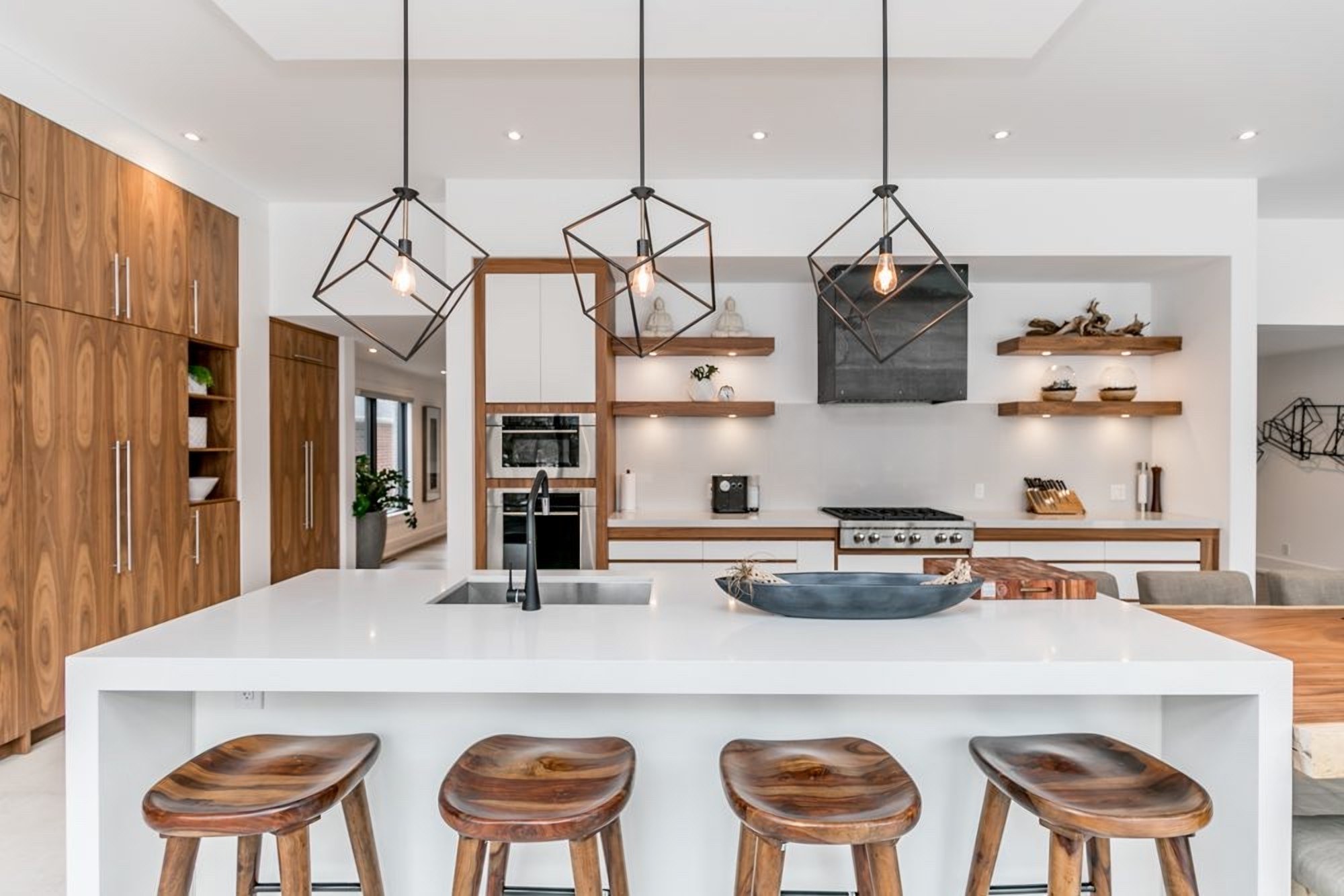 Kitchen with warm wood cabinetry and island by High Peaks Contracting Ltd.
