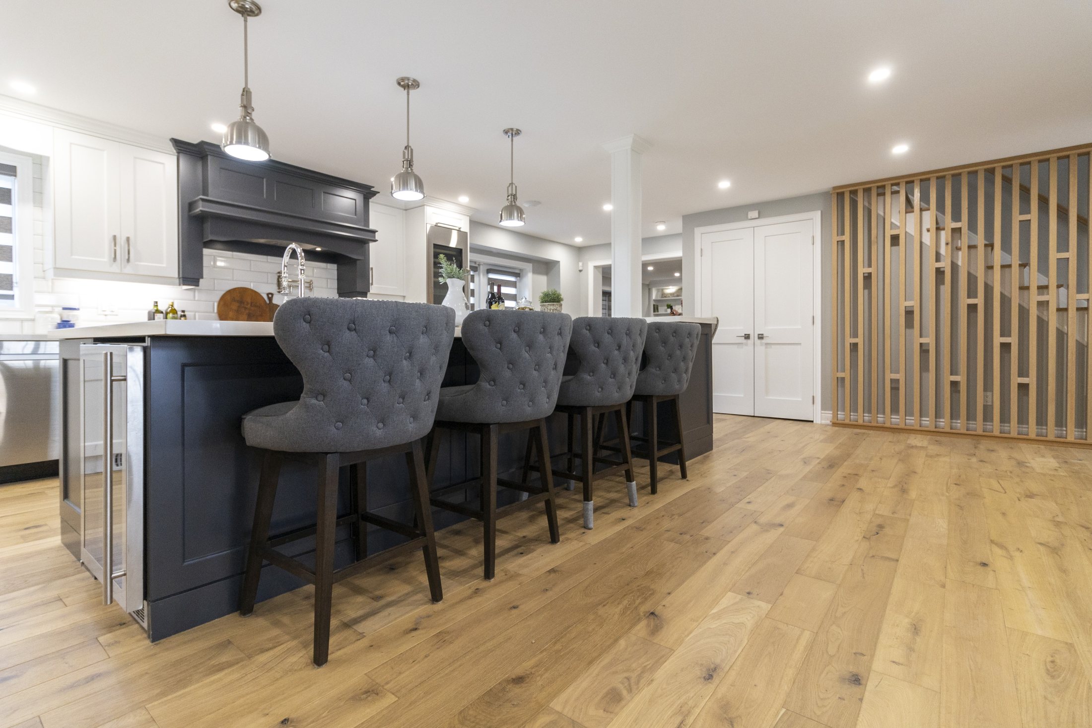 Kitchen island and custom wood slat feature wall in a Mississauga renovation by High Peaks Contracting Ltd.