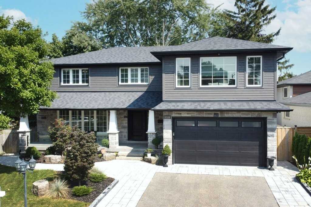 Home with a second-storey addition over the garage in Mississauga by High Peaks Contracting Ltd.